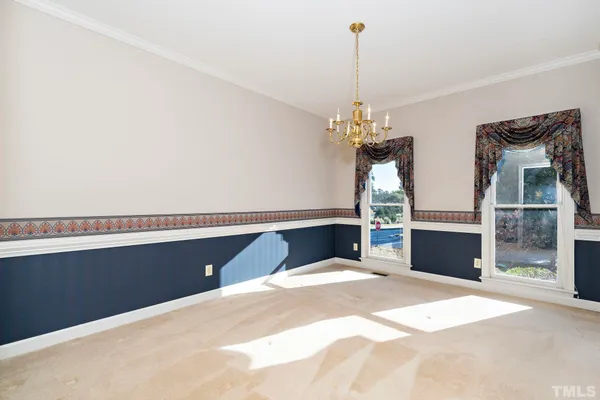 a bedroom with bed and a chandelier