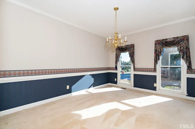 a bedroom with bed and a chandelier