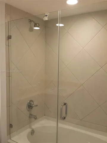a bathroom with a shower and a bathtub