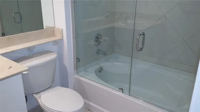 a white toilet sitting next to a bathtub