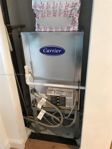 view of a room with water heater and wooden cabinets