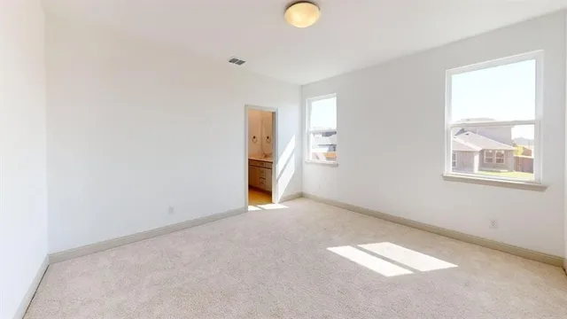 an empty room with windows and closet