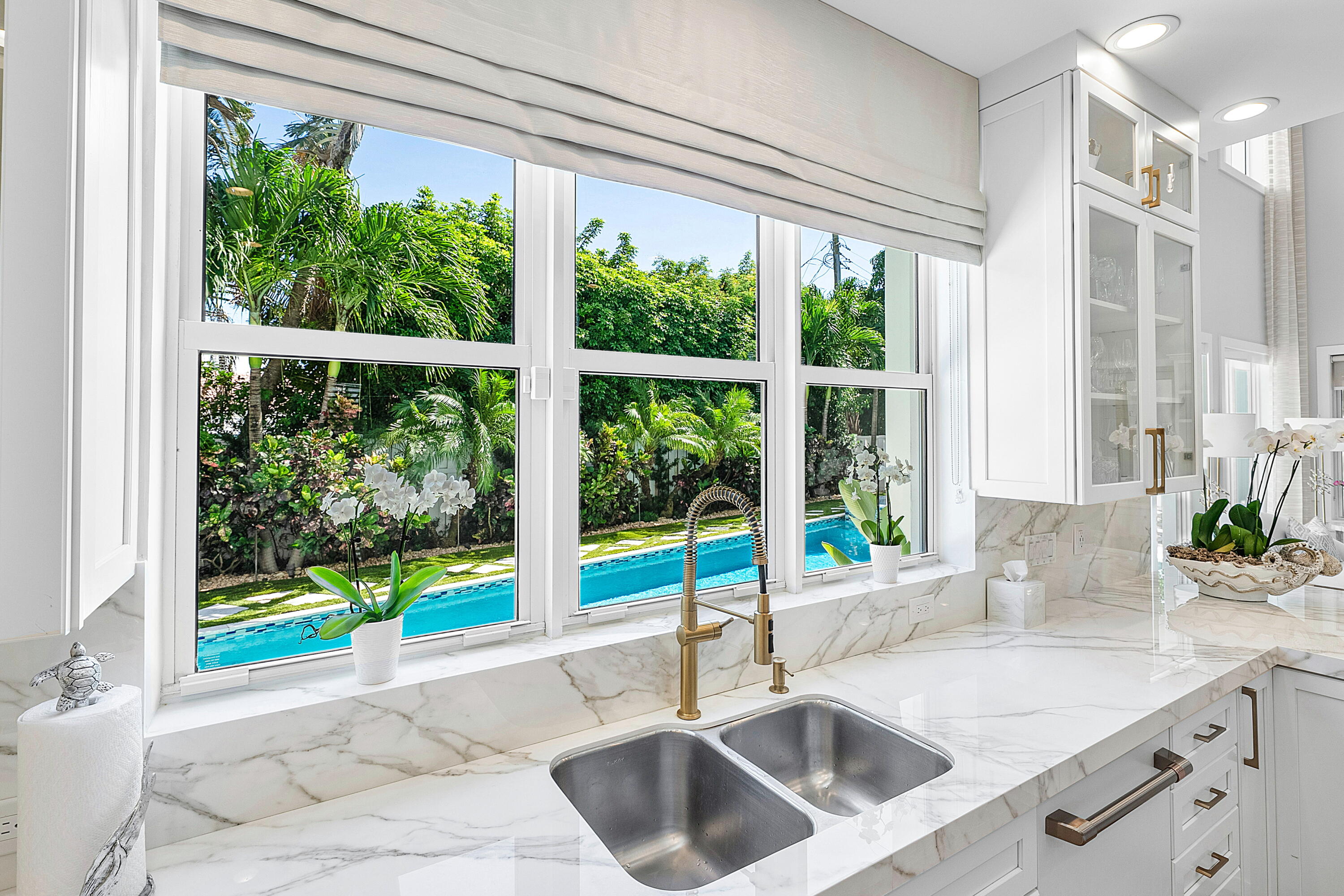 540 Northeast Spanish Trail Boca Raton, FL 33432 - Photo 18 of 47 a kitchen with a sink and a large window