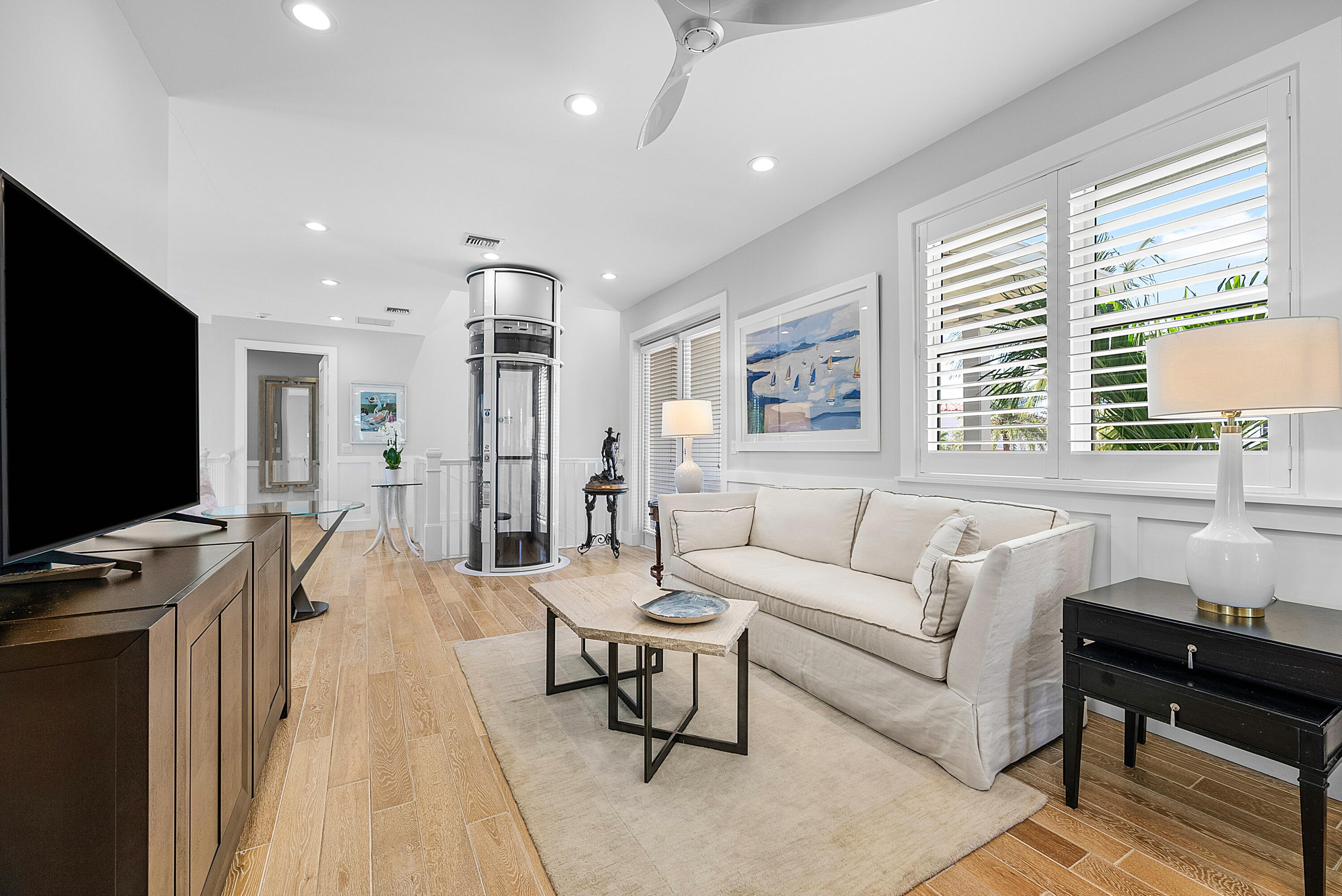 540 Northeast Spanish Trail Boca Raton, FL 33432 - Photo 23 of 47 a living room with furniture a flat screen tv and a large window