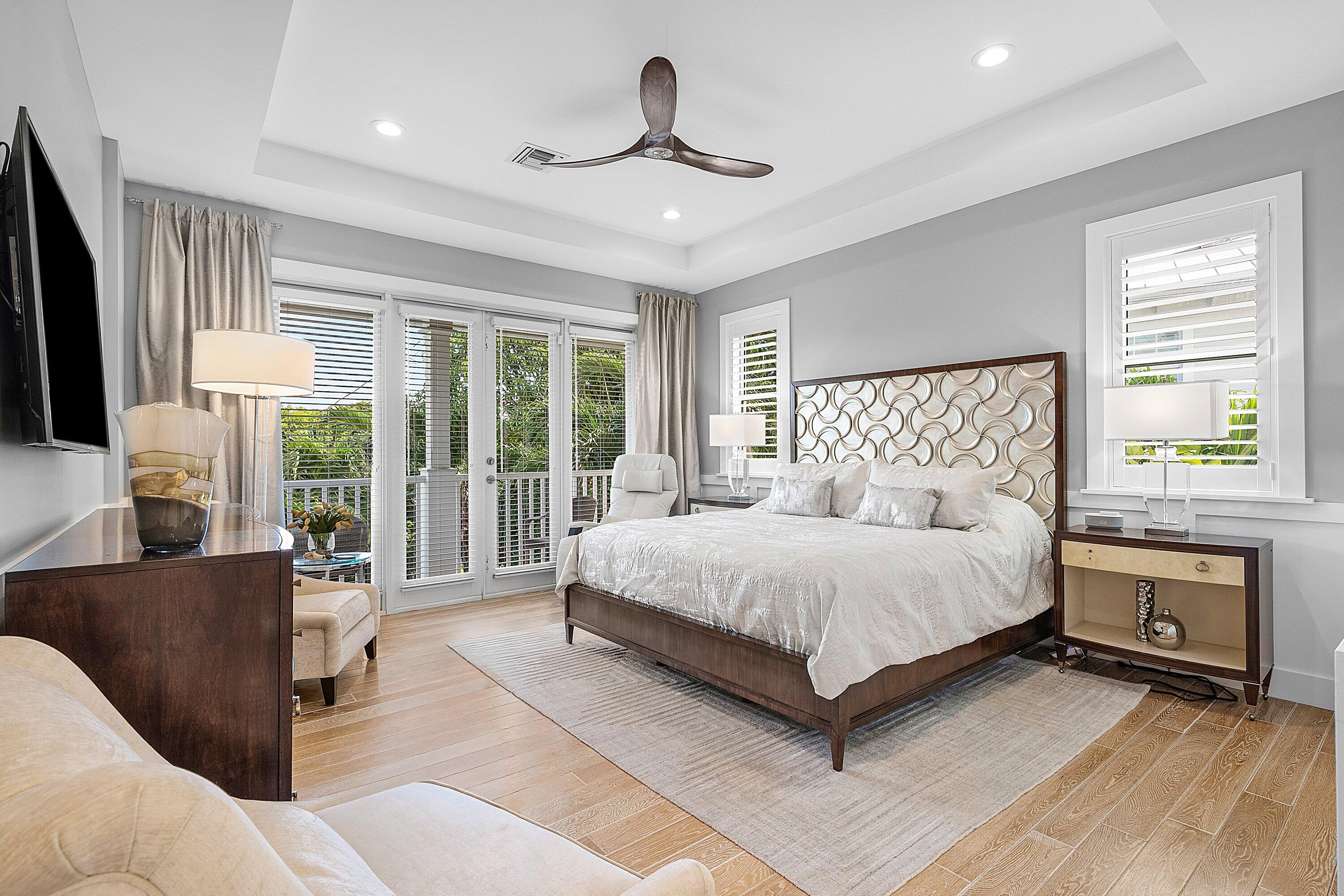 540 Northeast Spanish Trail Boca Raton, FL 33432 - Photo 24 of 47 a bedroom with a large bed and a large window