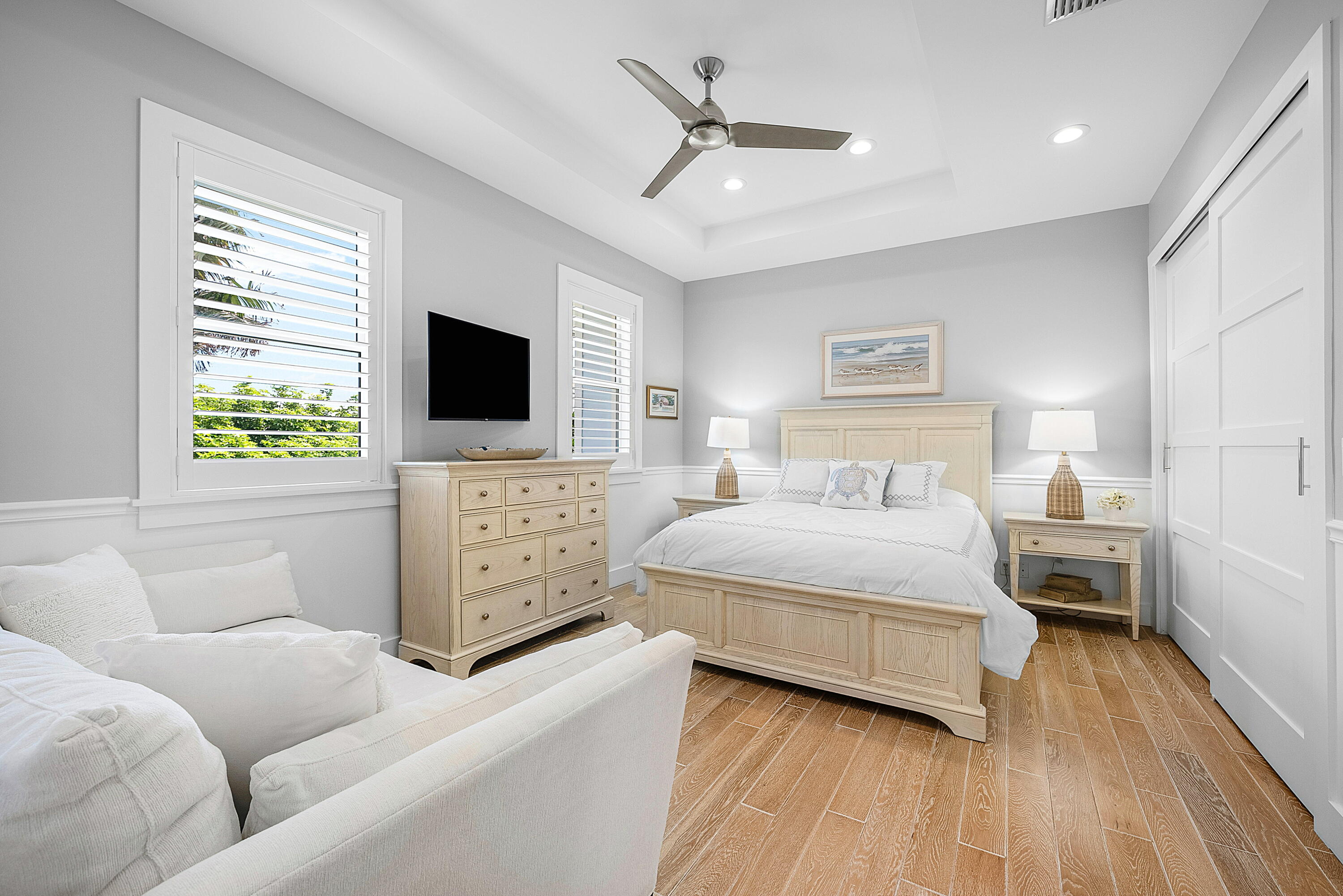 540 Northeast Spanish Trail Boca Raton, FL 33432 - Photo 30 of 47 a bedroom with a bed a couch and a window