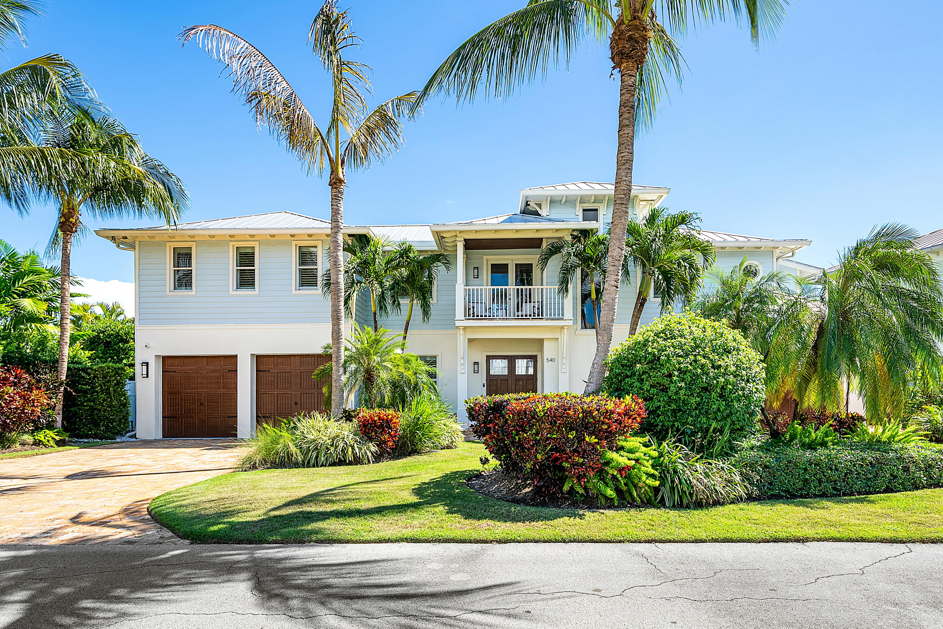 540 Northeast Spanish Trail Boca Raton, FL 33432 - Photo 3 of 47 a front view of a house with a garden