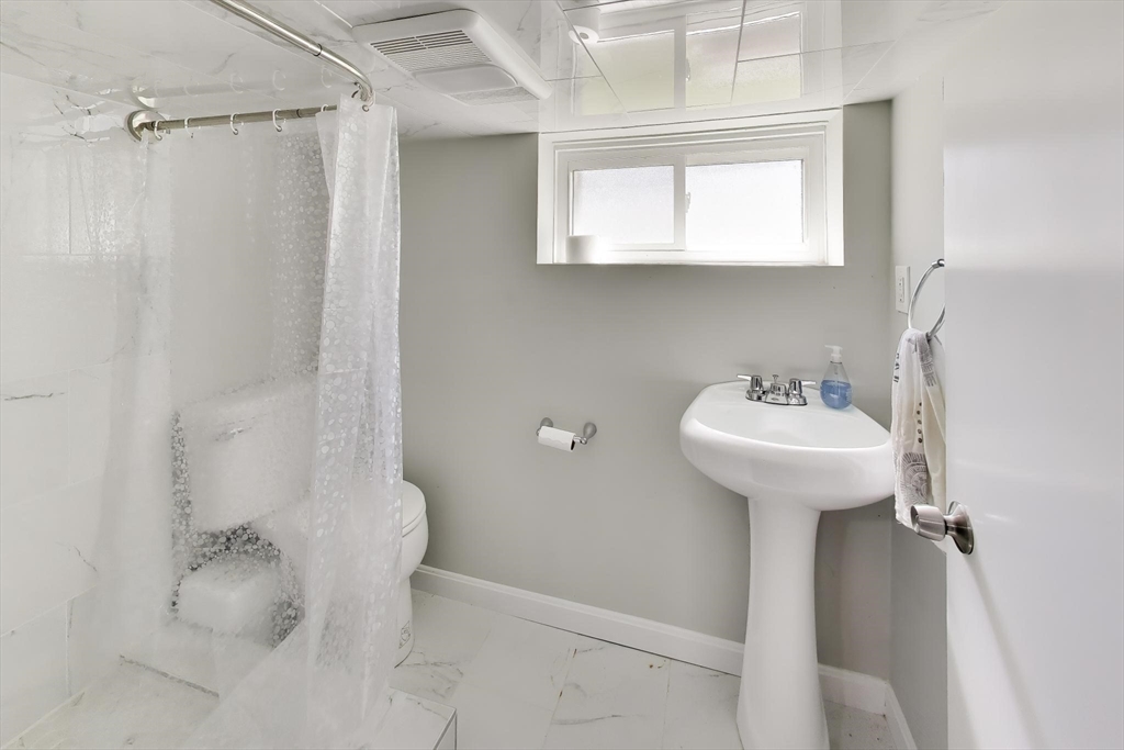22 Douglas Road Ashland, MA 01721 - Photo 20 of 24 a bathroom with a sink toilet and shower