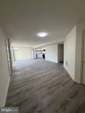 a view of a big room with wooden floor and stairs