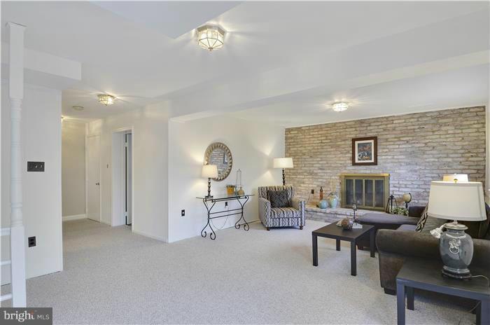 8723 Postoak Road Rockville, MD 20854 - Photo 26 of 30 Lower level family room with fireplace