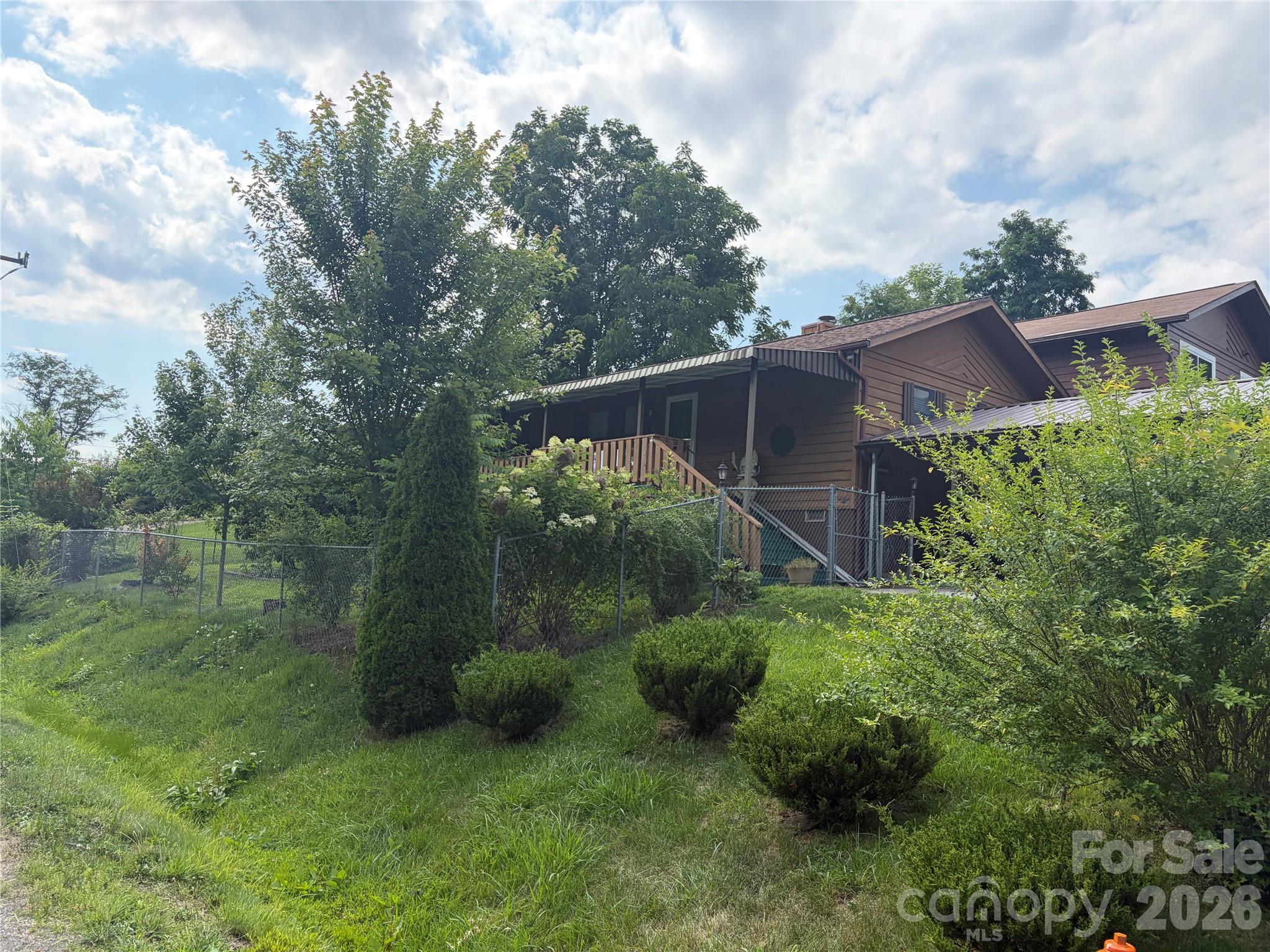 256 A Bruce Road Mars Hill, NC 28754 - Photo 14 of 39 a backyard of a house with lots of green space