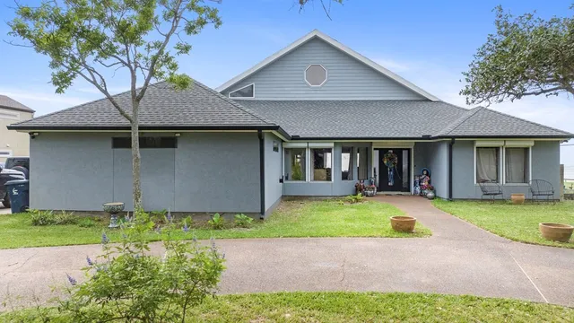 a front view of a house with a yard and porch