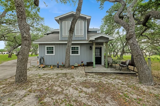 a kitchen with stainless steel appliances granite countertop a stove a sink and white cabinets