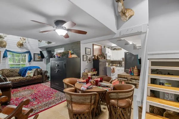 a living room with furniture a flat screen tv and a table
