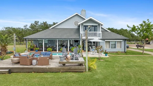 a front view of a house with garden and porch