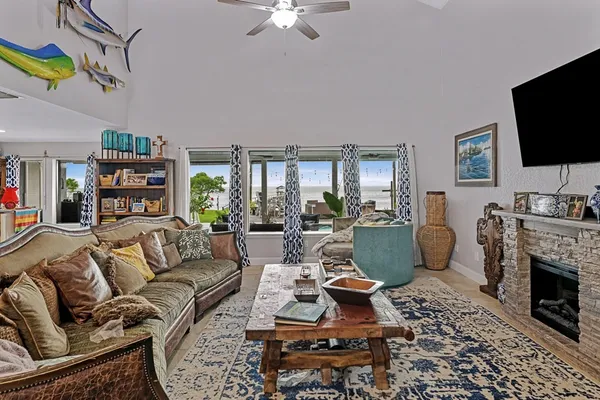 a living room with furniture a flat screen tv and a fireplace