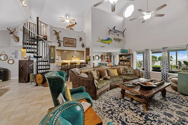 a living room with furniture a chandelier and a rug