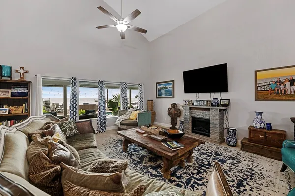 a living room with furniture a flat screen tv and a fireplace