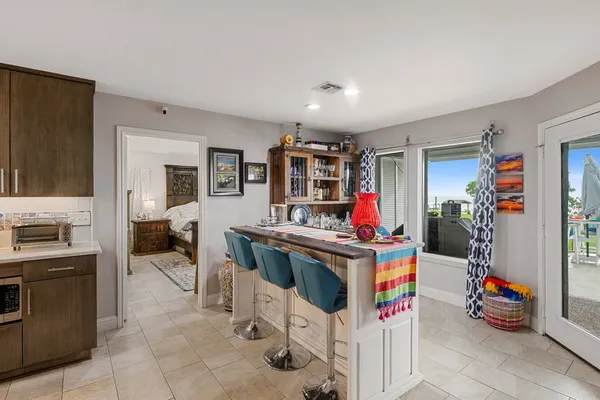 a view of a kitchen that has a lot of cabinets and a stove