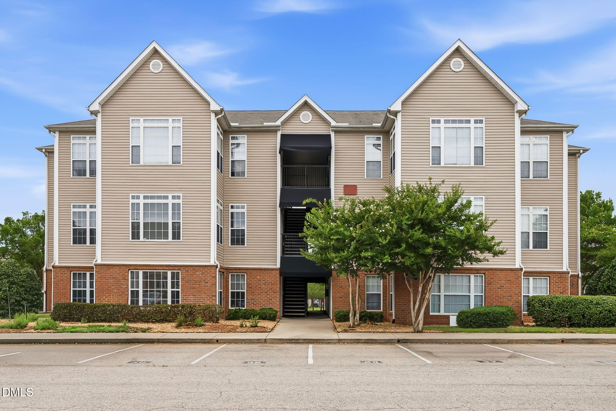 2501 Huntscroft Lane, Unit 100 Raleigh, NC 27617 - Photo 2 of 31 a front view of a house with a yard and plants