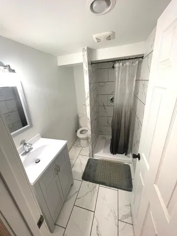 a bathroom with a sink a toilet and mirror