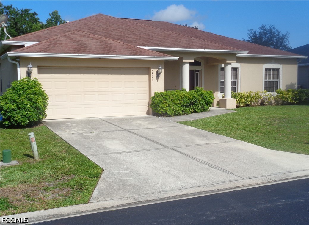 2463 Nature Pointe Loop Fort Myers, FL 33905 - Photo 2 of 50 a front view of house with yard