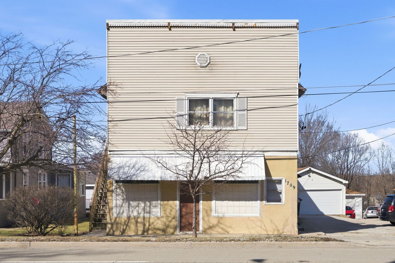 a front view of a house with a road