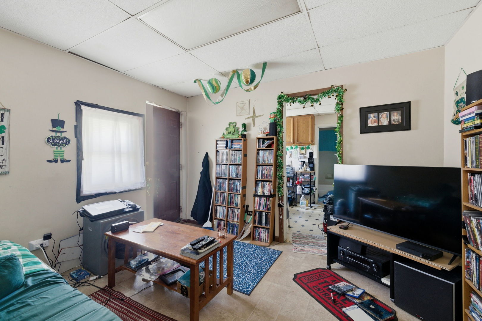 1709 South State Street Lockport, IL 60441 - Photo 19 of 26 a living room with furniture a flat screen tv and a wall painting