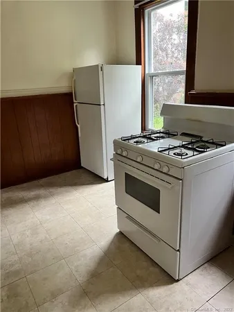 a stove top oven sitting inside of a kitchen