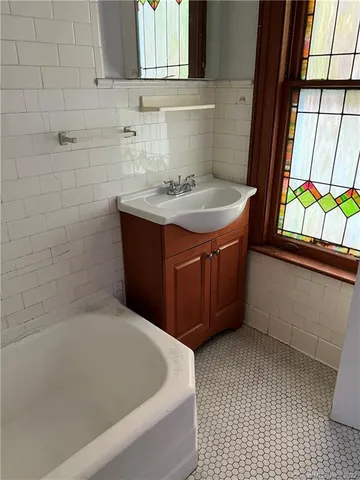 a bath tub sitting in a bathroom next to a window