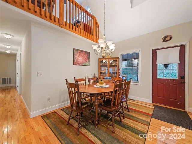 a view of a dining room with furniture and a chandelier