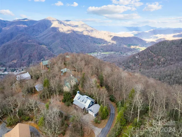 an aerial view of house with mountain view