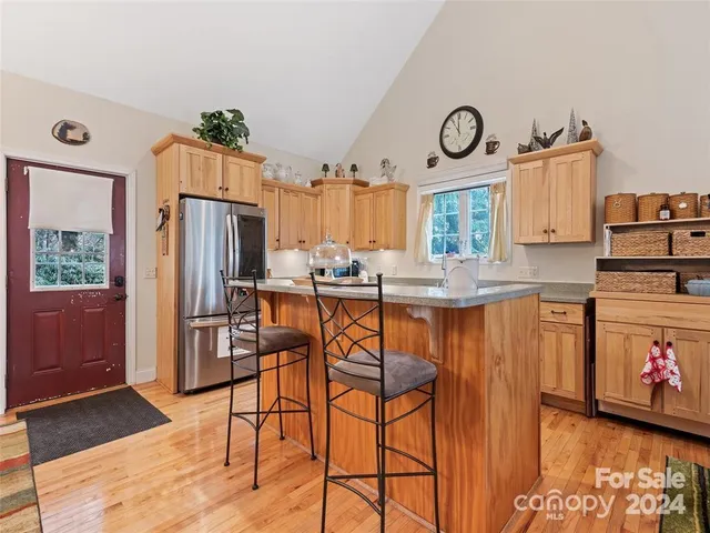 a kitchen with stainless steel appliances granite countertop a refrigerator and a stove top oven