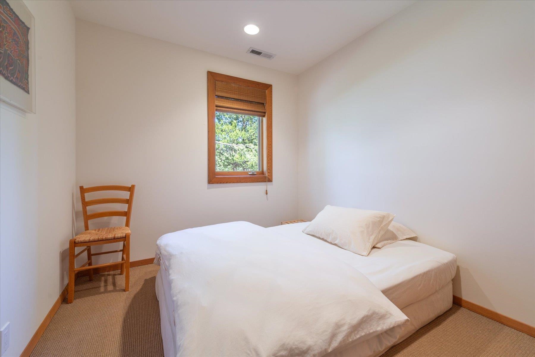 15009 Ski Slope Way Truckee, CA 96161 - Photo 15 of 28 a bedroom with a bed a dresser and a window