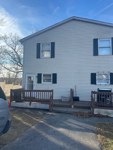 a view of a house with a wooden fence