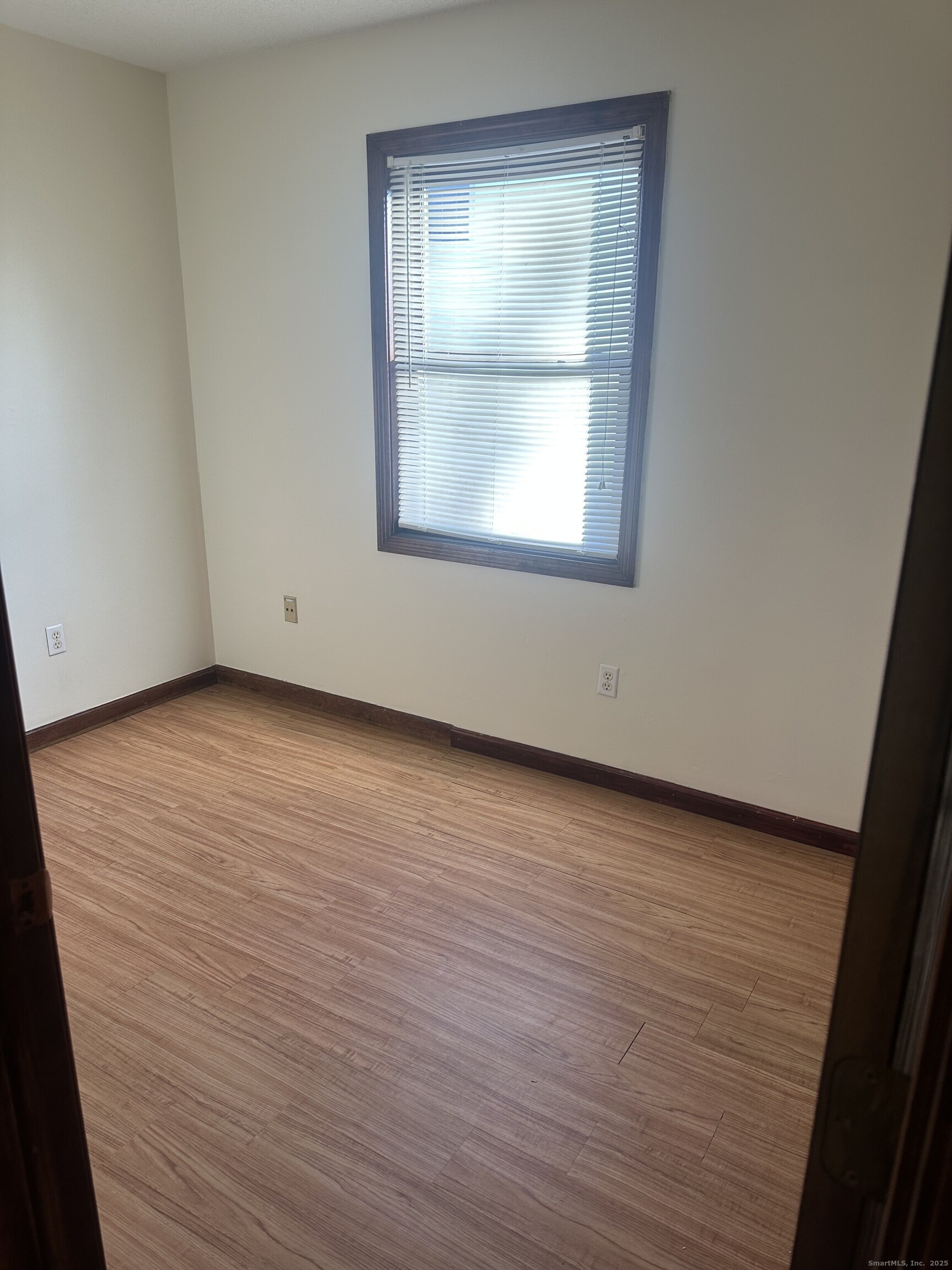 240 North Main Street, Unit A Ansonia, CT 06401 - Photo 4 of 5 an empty room with wooden floor and windows
