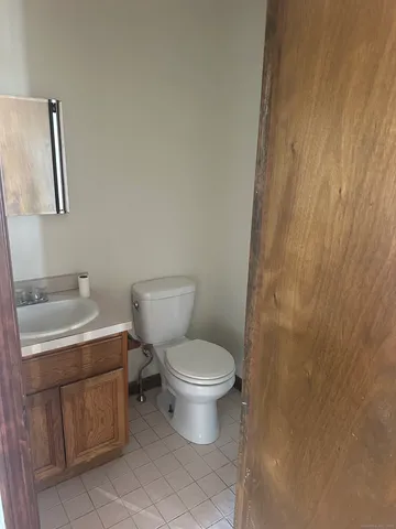 a white toilet sitting next to a bathroom sink