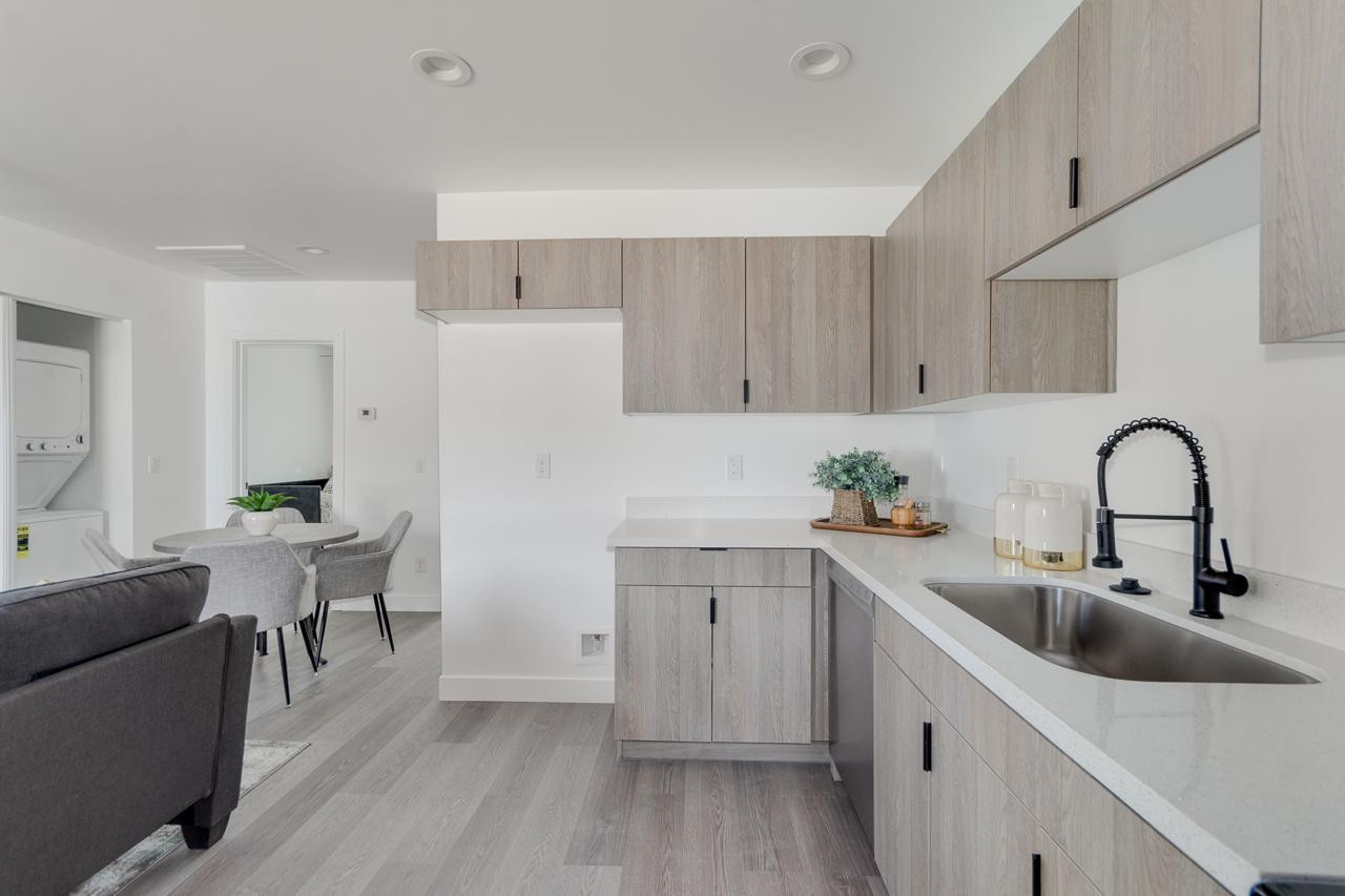 2512 East Thomas Road, Unit 1 Phoenix, AZ 85016 - Photo 11 of 24 a kitchen with a sink white cabinets and wooden floor