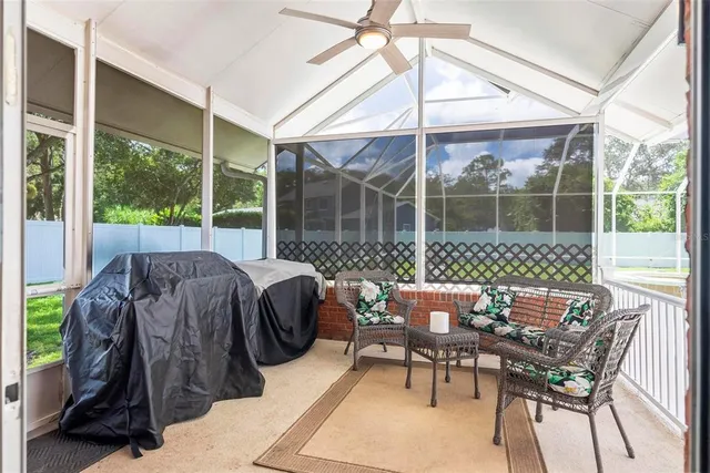 an aerial view of residential houses with outdoor space and trees