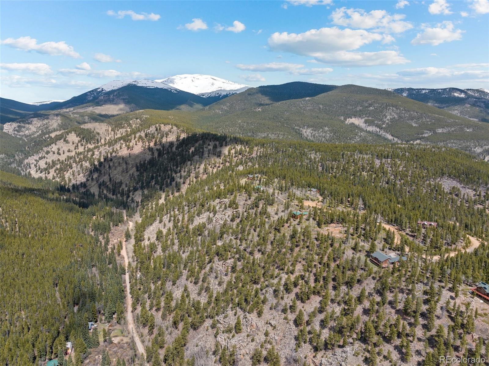 1364 Royal Ridge Drive Bailey, CO 80421 - Photo 30 of 30 a view of a city with mountains in the background