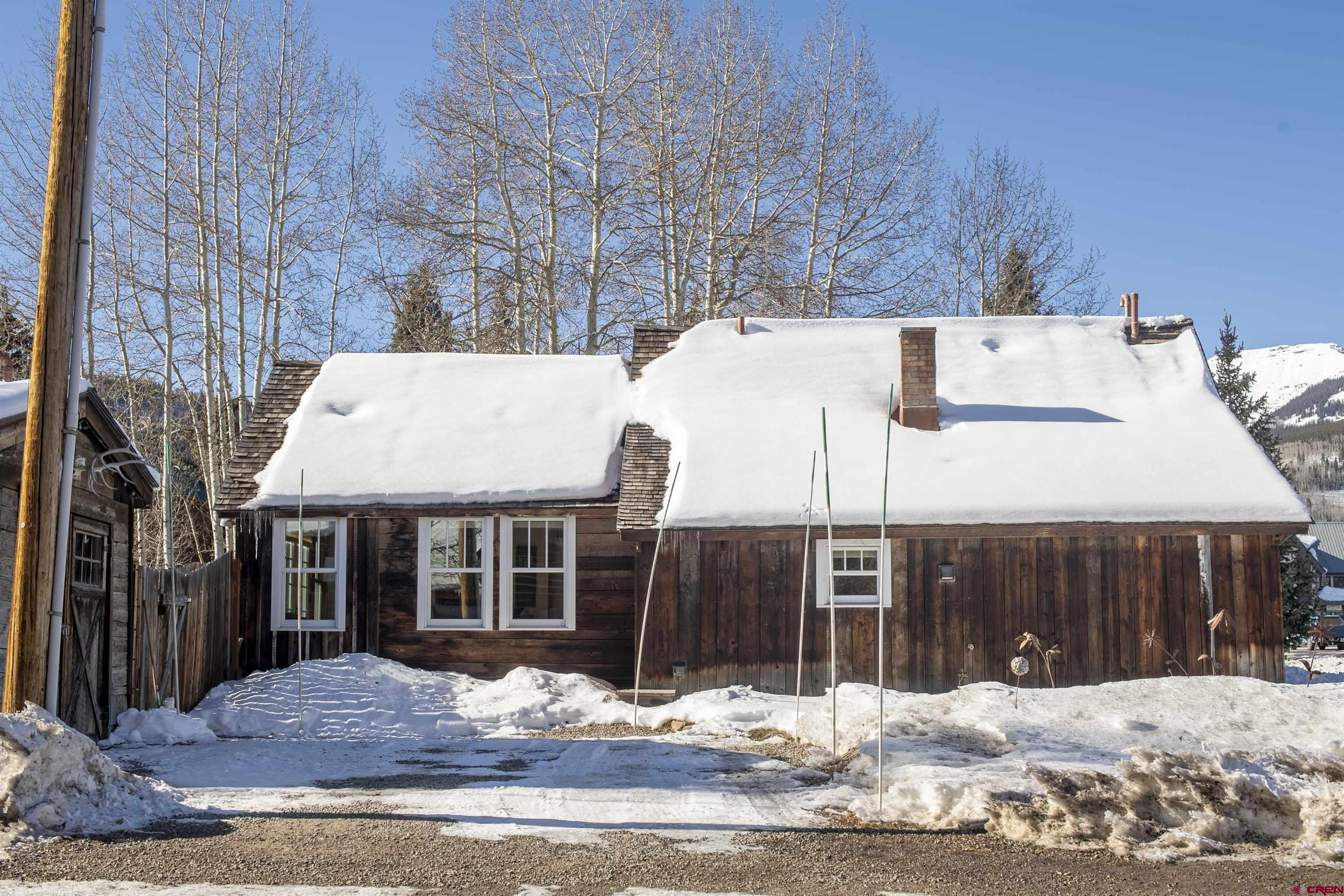 640 Elk Avenue Crested Butte, CO 81224 - Photo 1 of 45 a view of a house with a yard covered in snow
