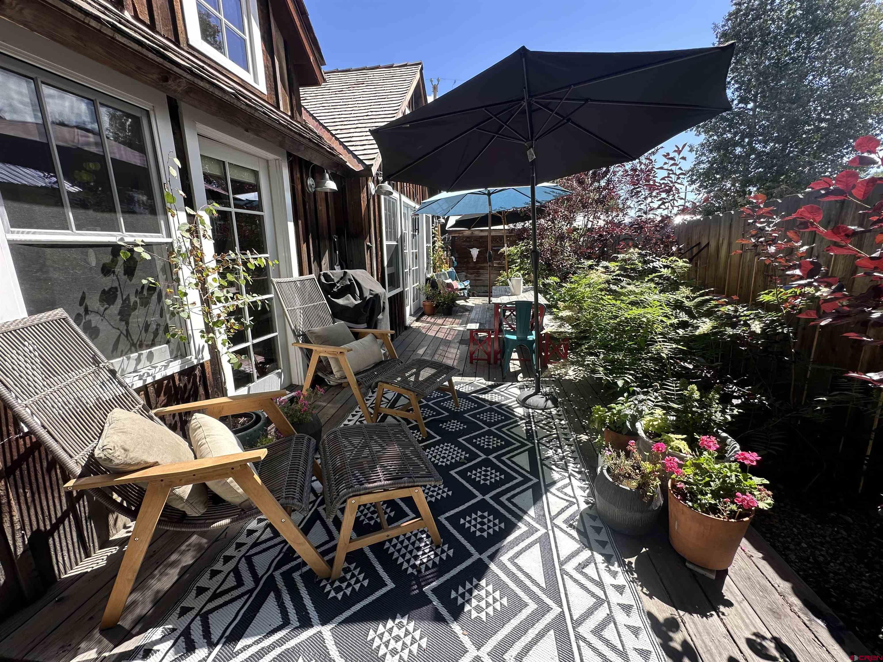 640 Elk Avenue Crested Butte, CO 81224 - Photo 16 of 45 a view of a chairs and table in the patio and a fire pit