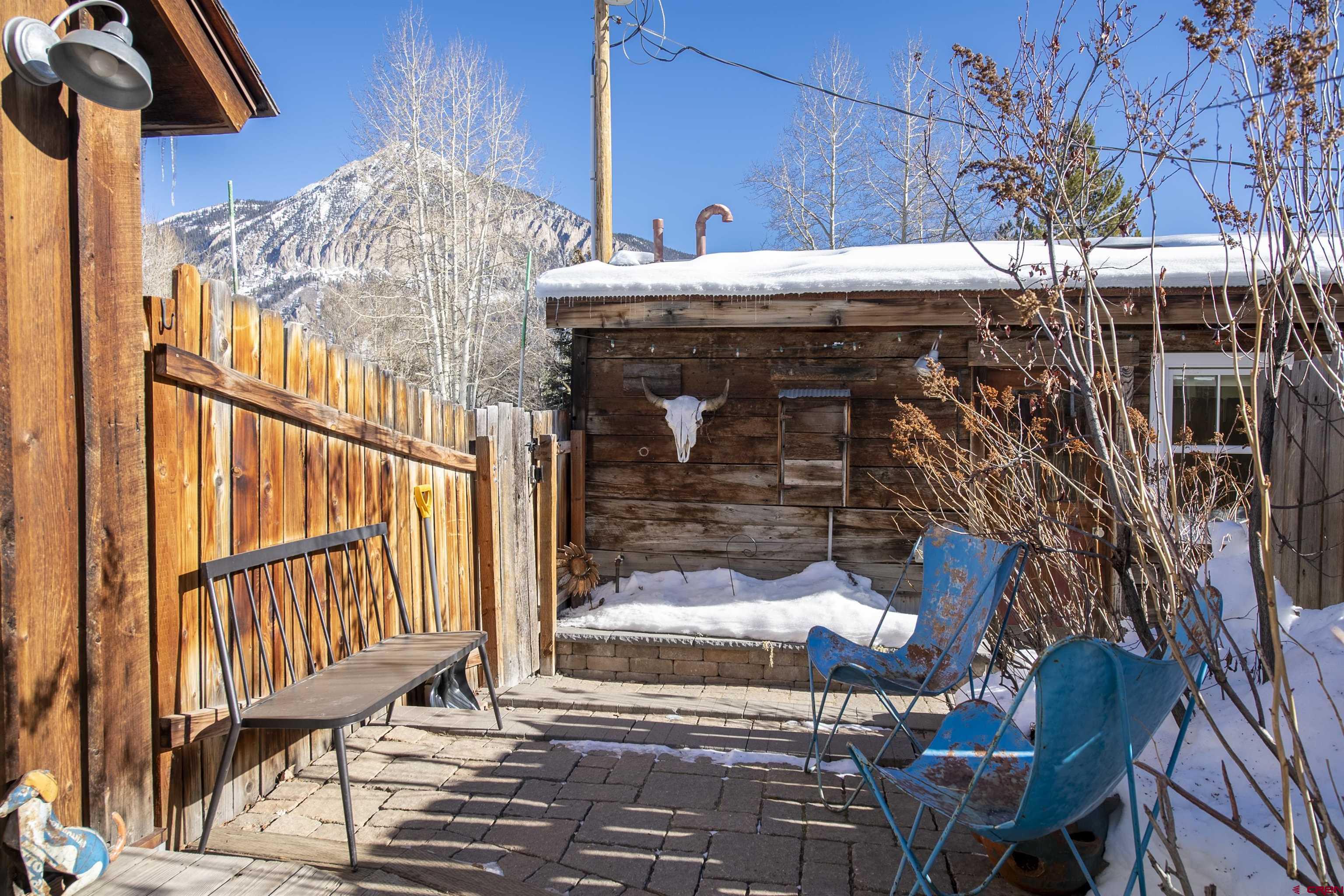 640 Elk Avenue Crested Butte, CO 81224 - Photo 19 of 45 a view of a balcony with chairs and table and chairs