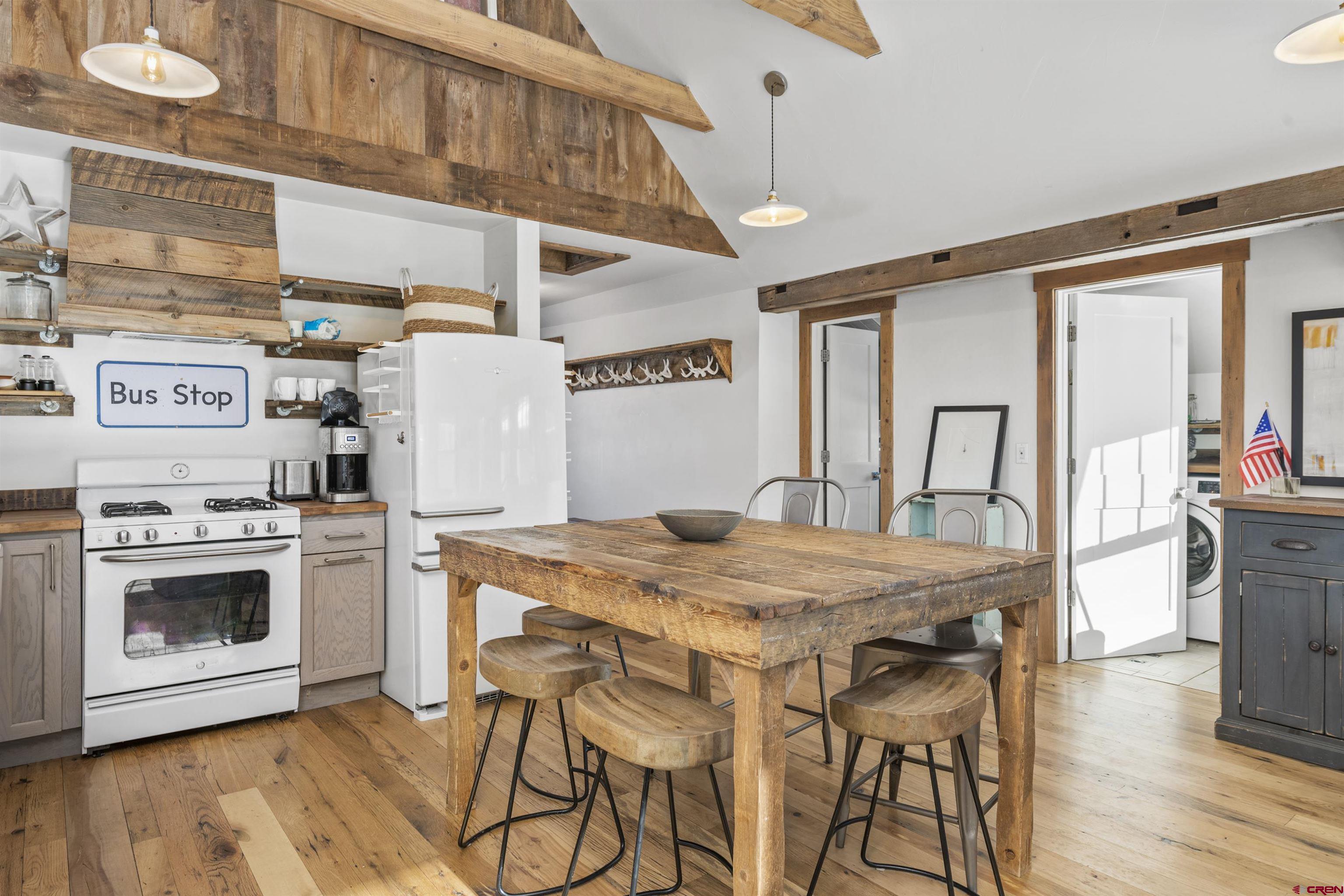 640 Elk Avenue Crested Butte, CO 81224 - Photo 29 of 45 a kitchen with a stove a refrigerator and a dining table view