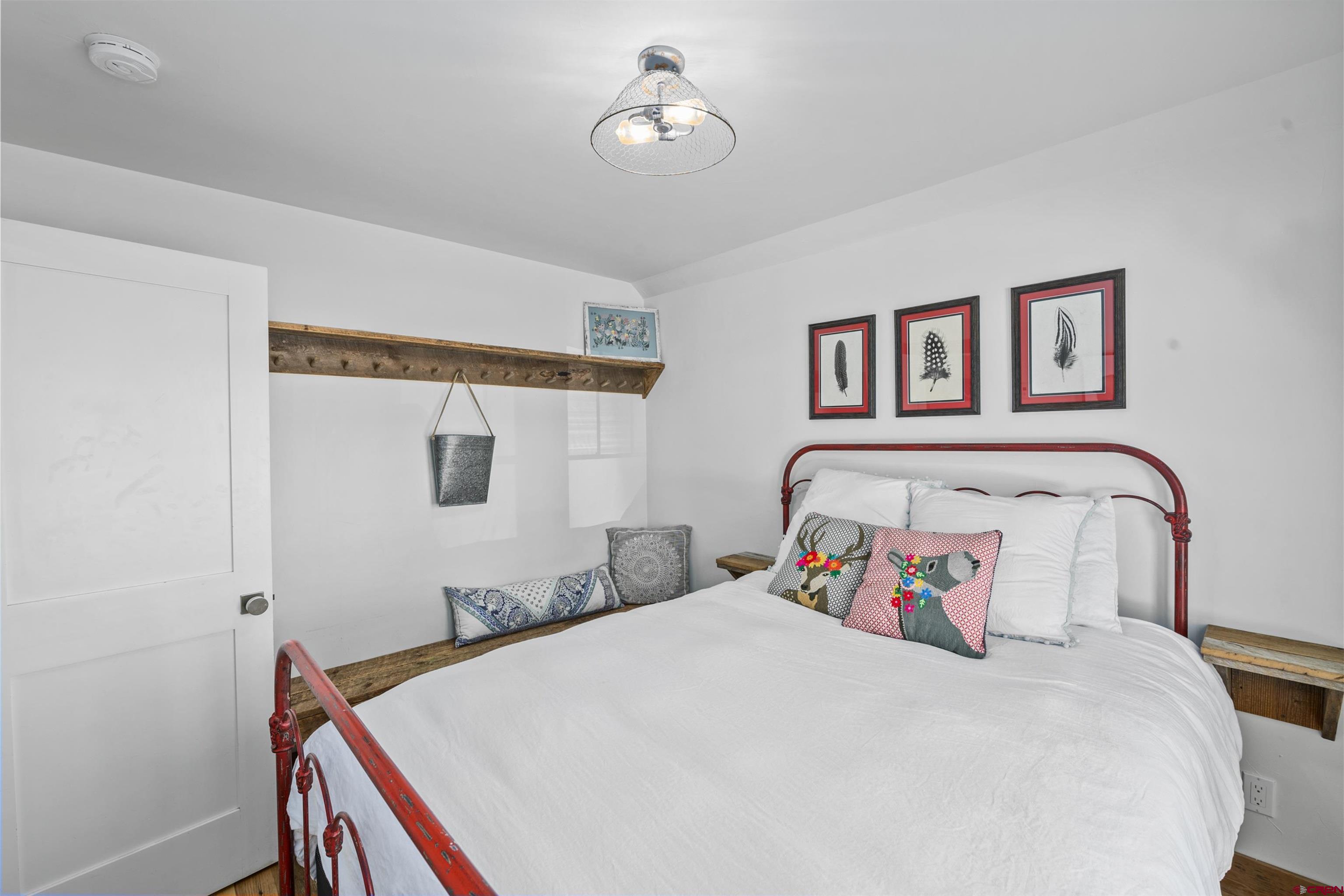 640 Elk Avenue Crested Butte, CO 81224 - Photo 38 of 45 a bedroom with bed and paintings on the wall