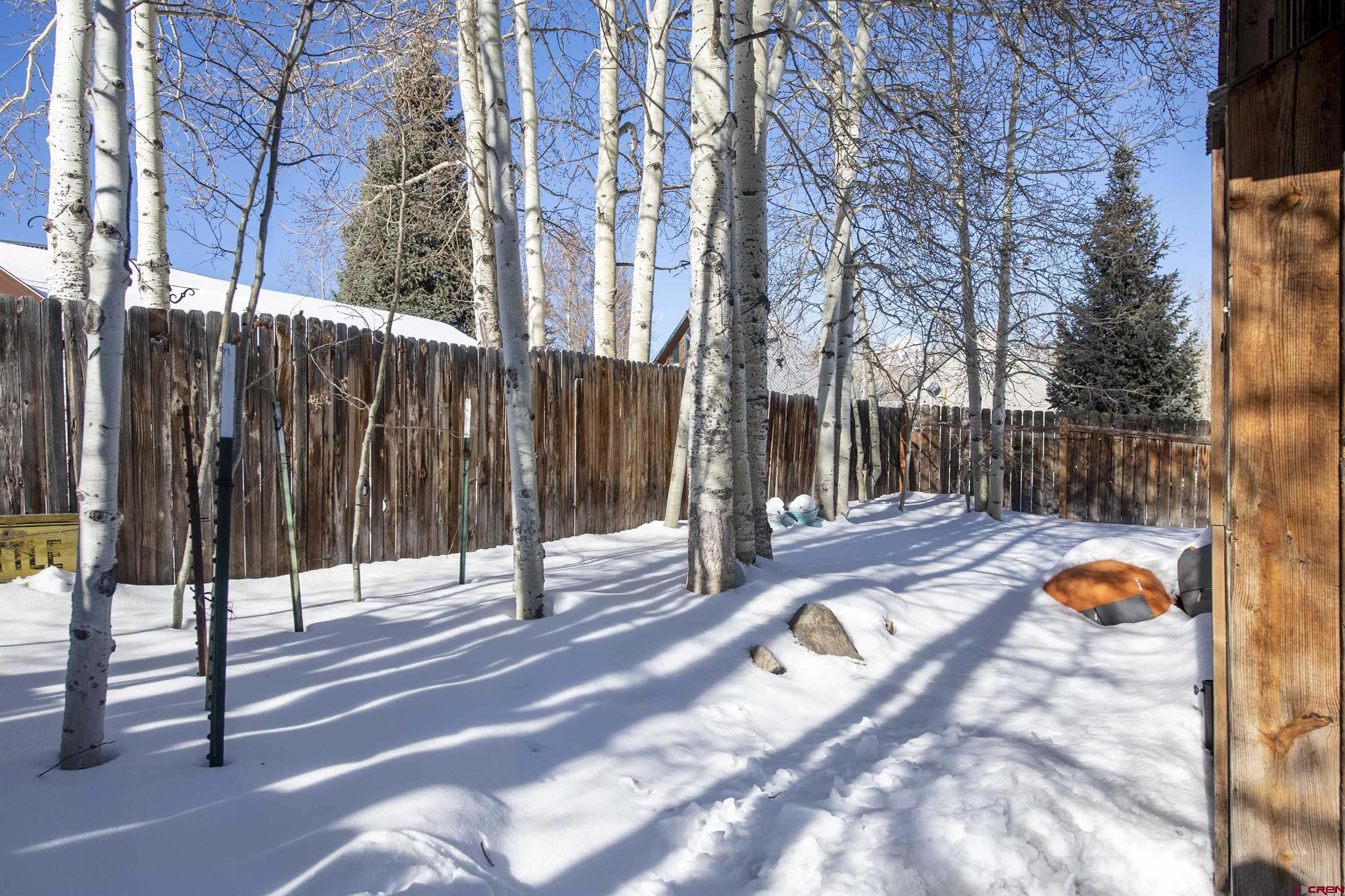 640 Elk Avenue Crested Butte, CO 81224 - Photo 5 of 45 a view of a street with brick wall and a large tree