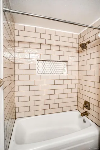 a bathroom with a bathtub and shower
