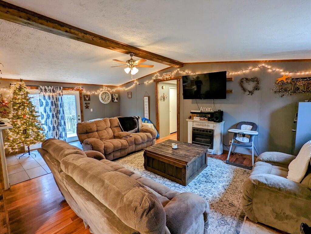 1555 Coles Knob Road Northeast Check, VA 24072 - Photo 3 of 27 a living room with furniture a flat screen tv and kitchen view