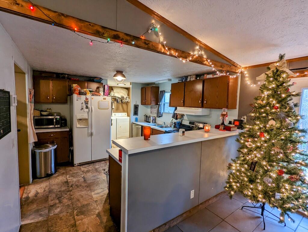 1555 Coles Knob Road Northeast Check, VA 24072 - Photo 5 of 27 a kitchen filled with stainless steel appliances kitchen island granite countertop a refrigerator and a stove top oven