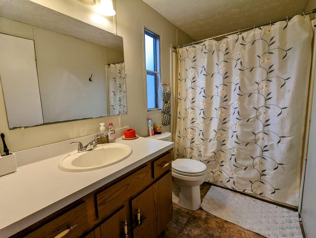 1555 Coles Knob Road Northeast Check, VA 24072 - Photo 10 of 27 a bathroom with a sink toilet and shower